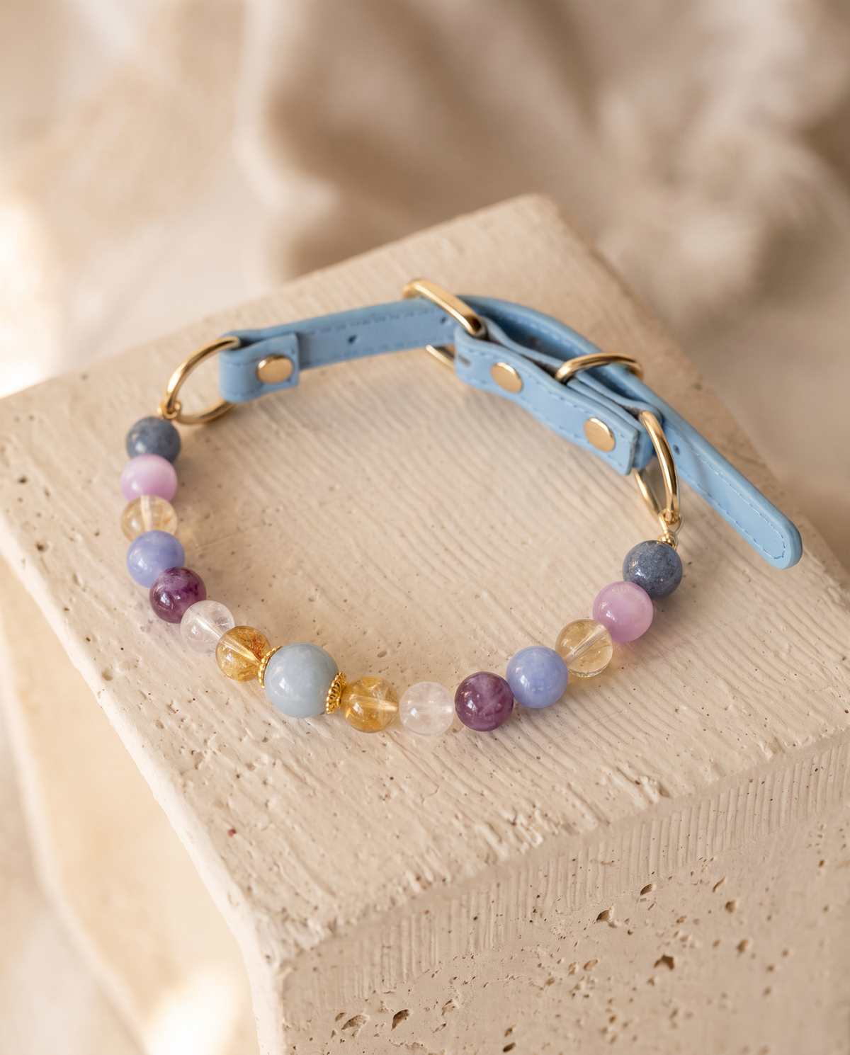 Companion Glow multicolor gemstone dog collar with powder-blue strap and gold-tone hardware