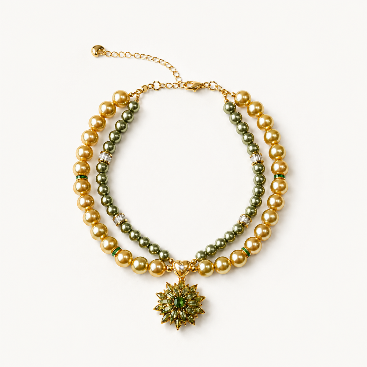 Double-strand champagne and olive pearl-effect pet necklace with a green floral pendant on a white surface.