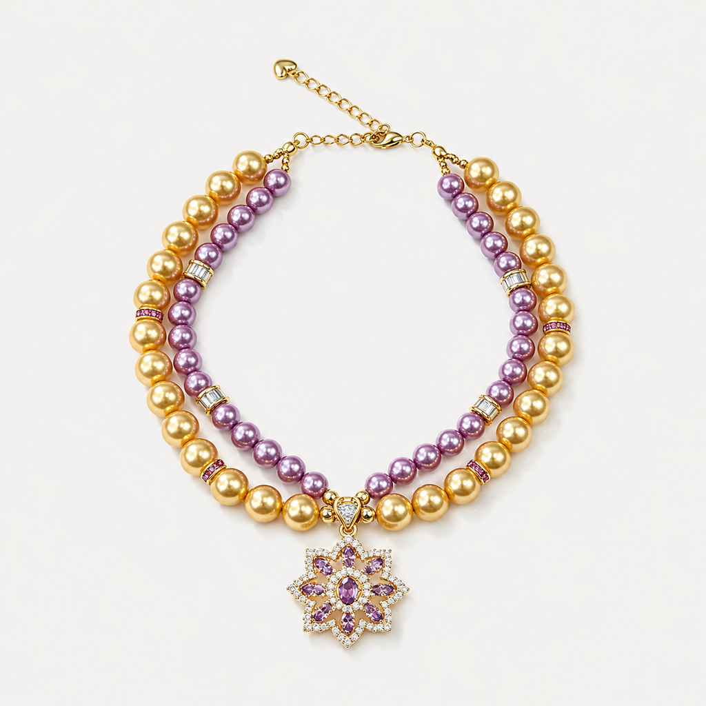 Double-strand purple and champagne pearl-effect pet necklace with a purple floral pendant on a white surface.