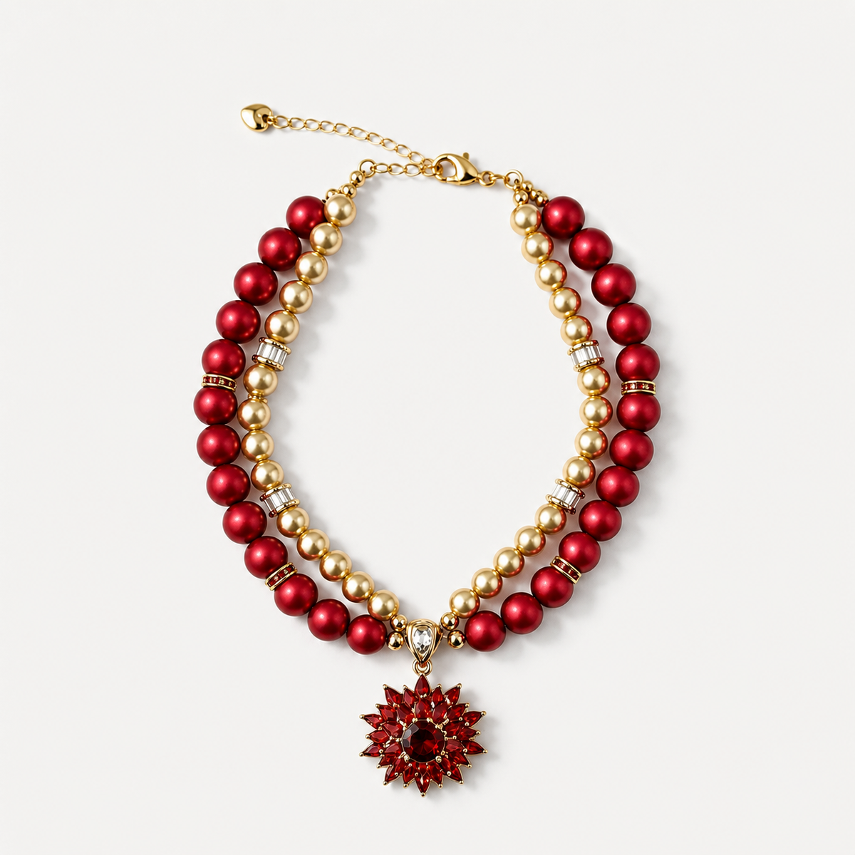 Double-strand red and champagne pearl-effect pet necklace with a red floral pendant on a white surface.