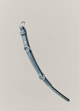 Dusty blue braided leather collar extended on a neutral background