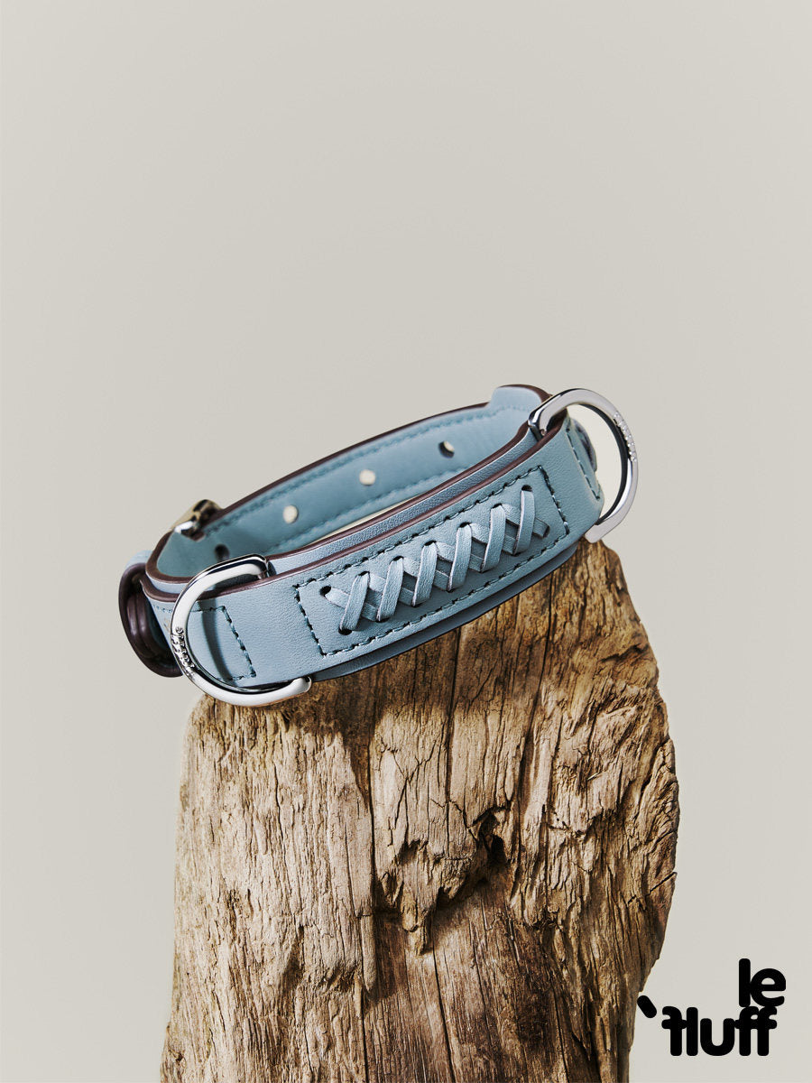 Dusty blue braided dog collar displayed on a wooden stump