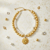 Elegant gold dog necklace with double-layer pearl-effect beads, adjustable chain and sunflower charm