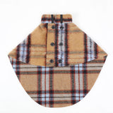 Tan and red plaid dog cape with front buttons, laid flat.