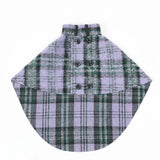 Green and gray plaid dog cape with front buttons, laid flat.