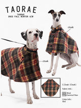 Dogs modeling plaid capes with a fabric detail inset.