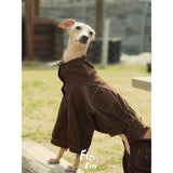 Seated dog wearing a brown utility suit with back pocket detail.