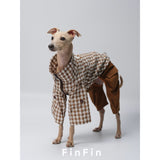 Dog wearing a brown check jacket over brown trousers.