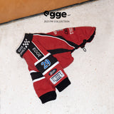 Red dog racing jacket laid flat with embroidered patches visible.