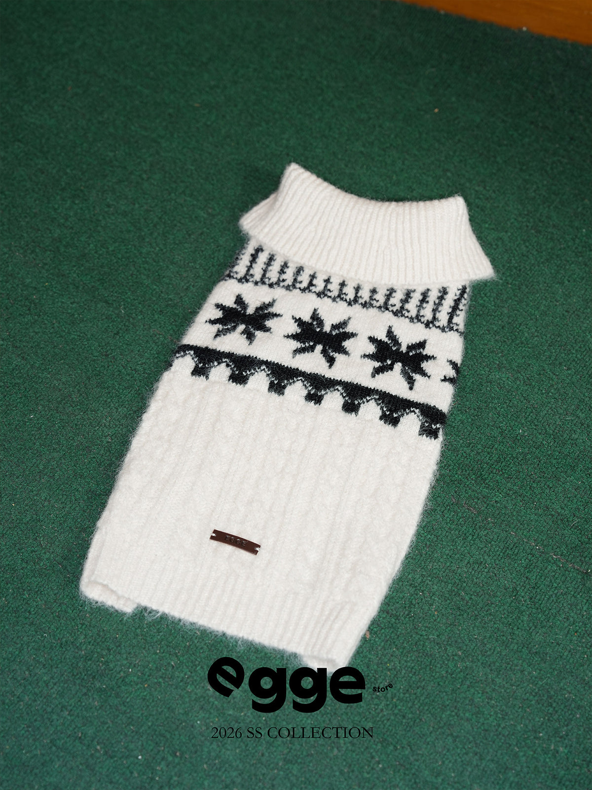 Egge white Fair Isle dog sweater with a ribbed collar and black snowflake pattern.