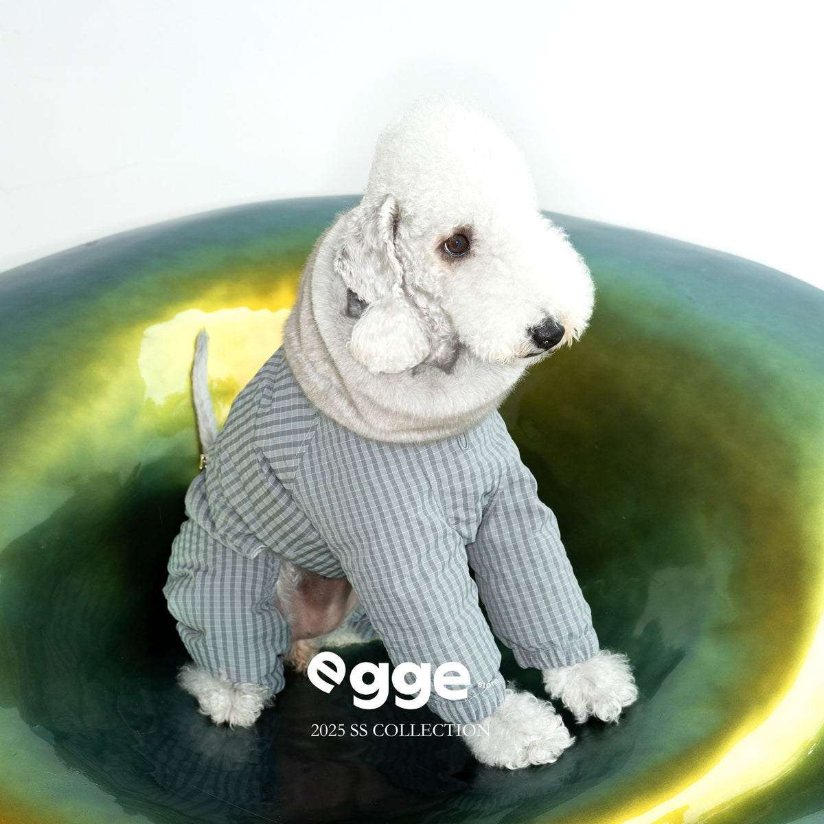 Gray check dog puffer bodysuit with a cream fluffy collar.