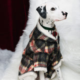 Side view of a plaid hooded coat on a seated Dalmatian.