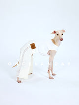 White dog trousers with decorative side trim, modeled from the side.