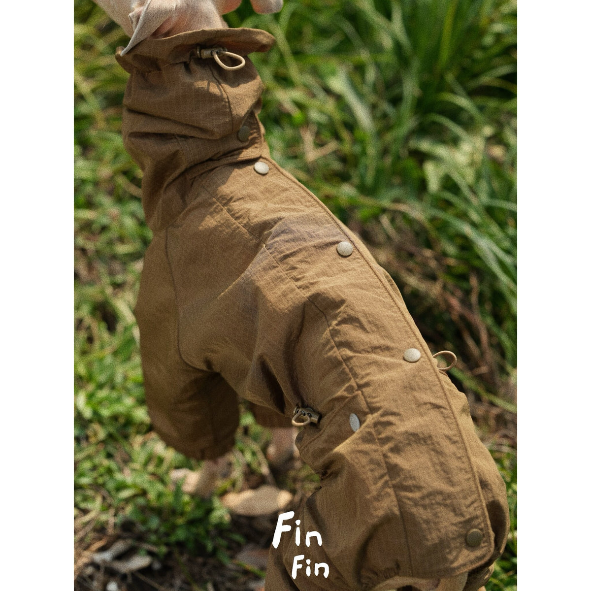 Close-up of a brown dog outdoor suit with back snap fastenings.