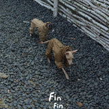 Overhead view of dogs in brown and beige outdoor bodysuits.
