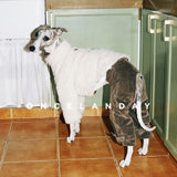 Side view of a white fluffy dog coat worn with dark trousers.