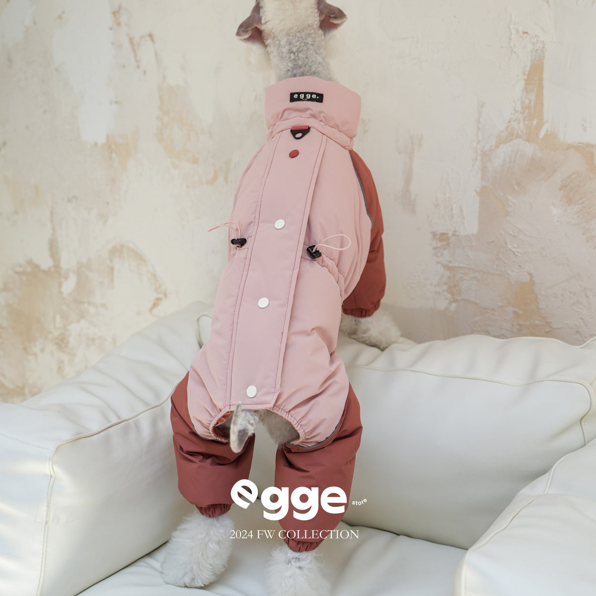 Rear view of a pink dog puffer bodysuit with snap fastenings.