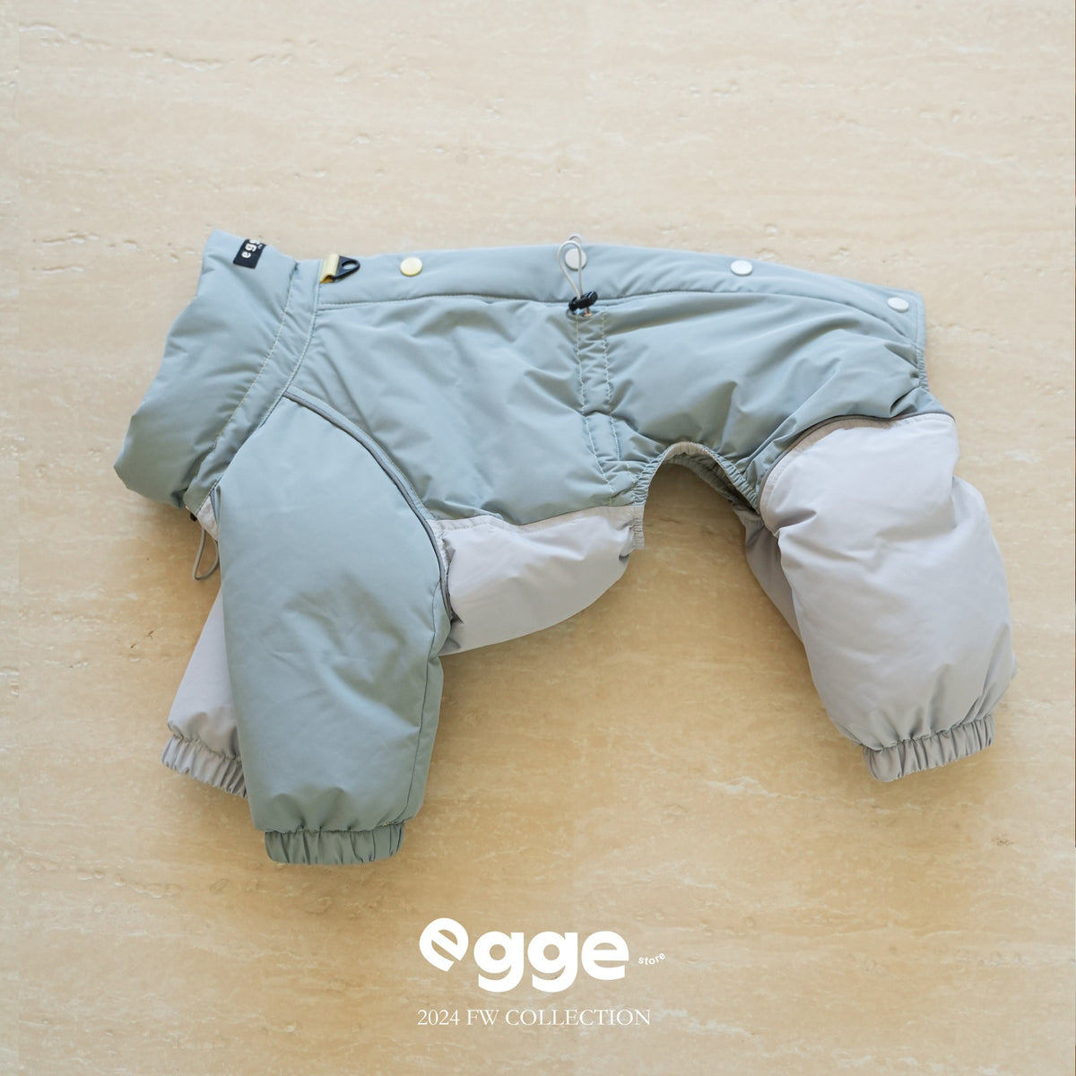 Mint and gray four-leg dog puffer bodysuit laid flat.