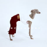 Side view of red dog jeans worn with a white tank.