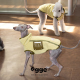 Dogs modeling pale yellow vests with contrasting pockets.