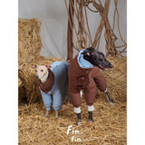 Two dogs wearing blue and brown puffer bodysuits.
