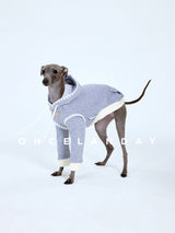 Side view of a lavender dog sweater with cream trim.