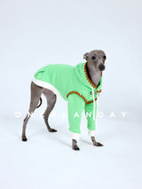Side view of a green dog sweater with cream cuffs.
