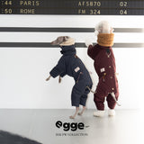 Rear view of navy and burgundy dog puffer suits.