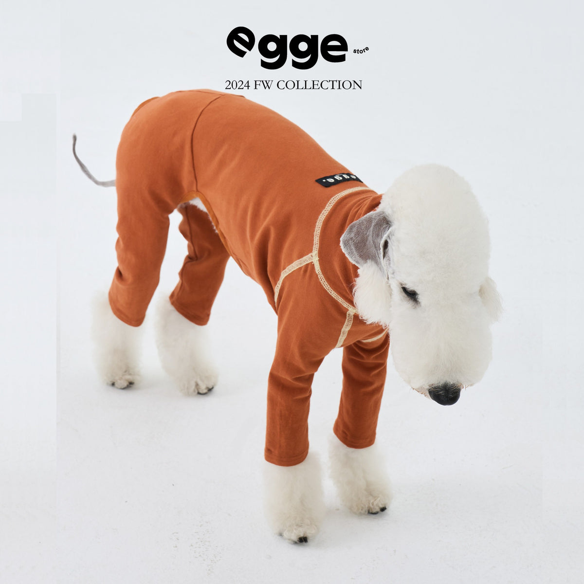 Orange dog bodysuit with light-colored seam trim.