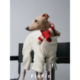 Dog wearing a red and cream striped scarf over a white bodysuit.