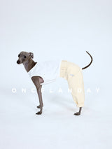 Side view of cream dog trousers with a waistband patch.