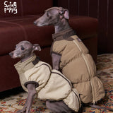 Two dogs wearing cream and tan padded vests with brown trim.