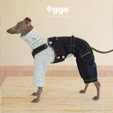Side view of dark denim overalls worn over a striped dog shirt.