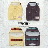 Yellow and dark harness vests laid flat to show front and buckle straps.