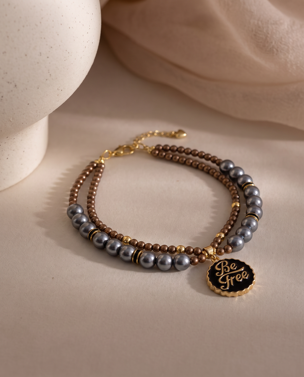 Silver Moon charcoal pearl-effect dog necklace with brown beads and gold-tone Be Free pendant