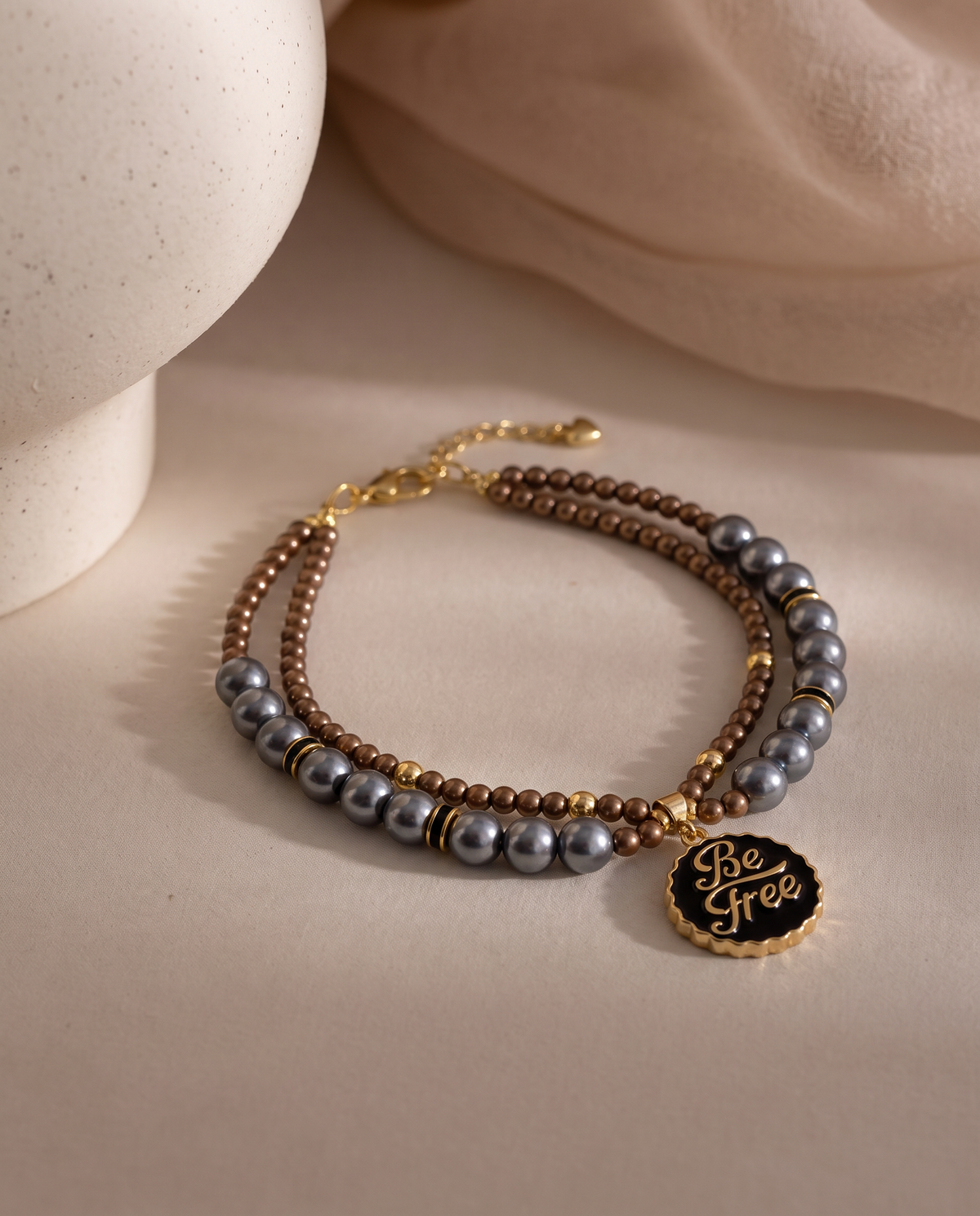 Silver Moon charcoal pearl-effect dog necklace with brown beads and gold-tone Be Free pendant