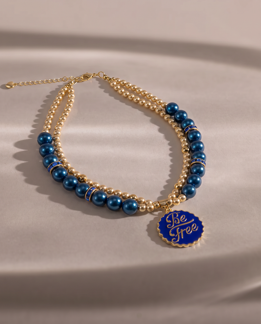 Ocean Whisper deep blue pearl-effect dog necklace with gold-tone Be Free pendant