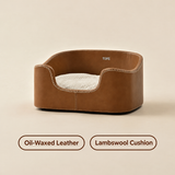 Oil-Waxed Heritage pet bed in brown leather-look material with a lambswool cushion