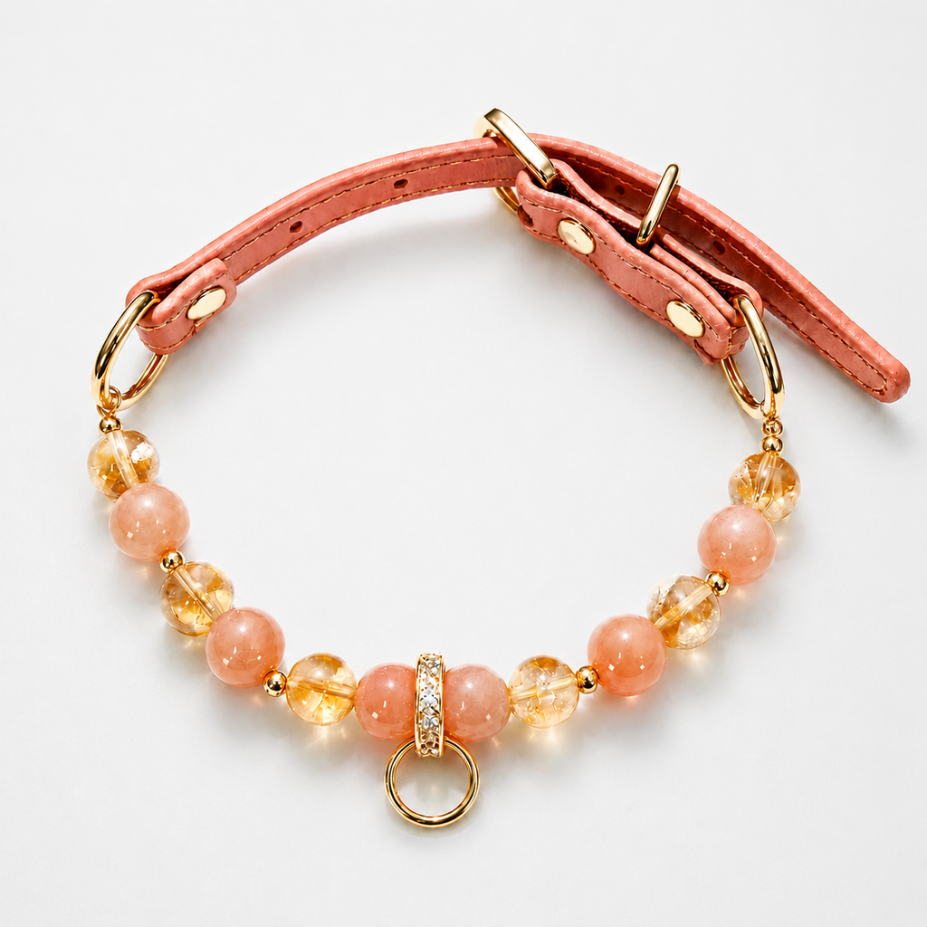 Pet collar with orange and golden gemstone beads, a brown adjustable strap and a gold-tone ring.