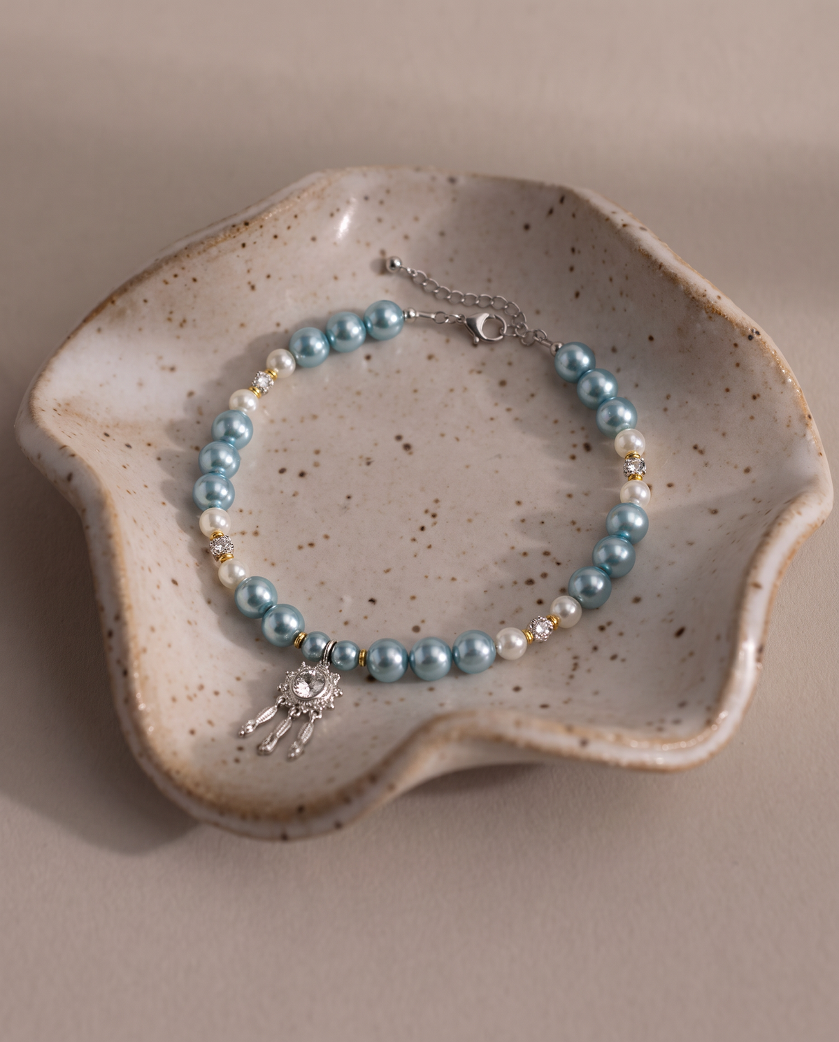 Radiant Meteor seafoam-blue pearl-effect dog necklace with silver-tone shooting-star pendant
