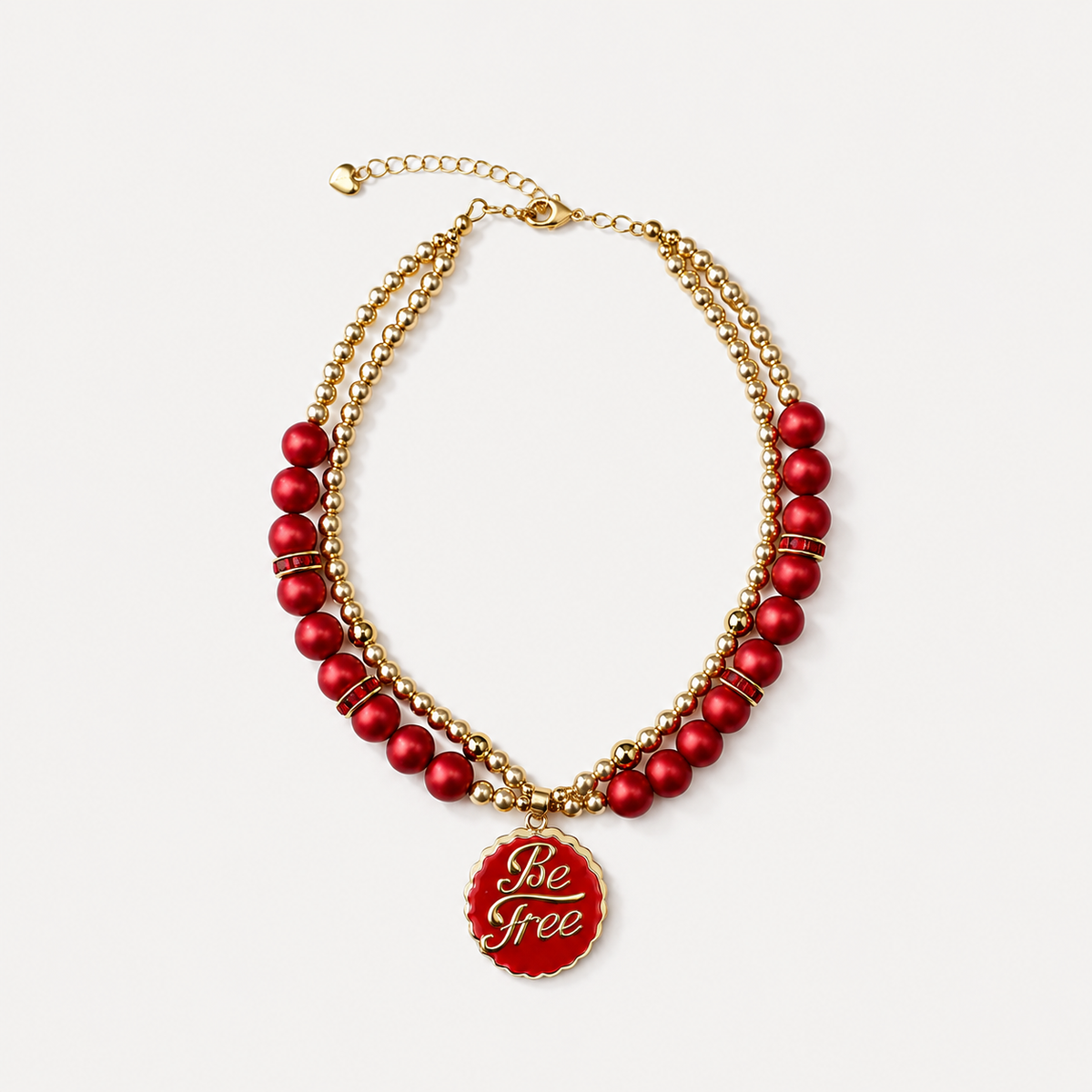 Red pearl-effect pet necklace with gold-tone beads and a red Be Free pendant on a white background.
